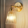 Industrial brass and clear textured glass wall sconce dining room