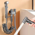 Matte black hygienic bidet sprayer with coiled hose for bathroom