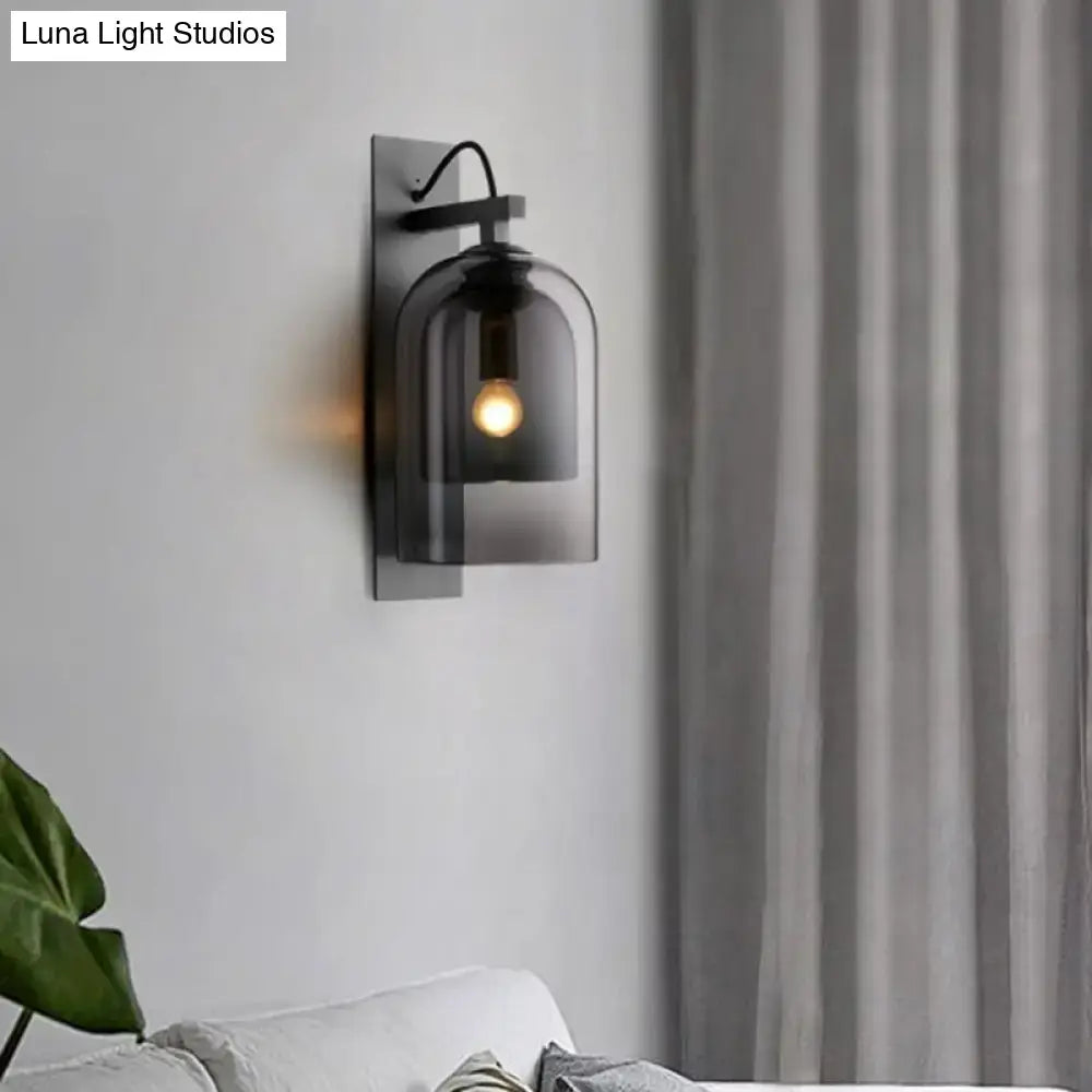 Mid-century black wall sconce with smoked dome glass shade living room
