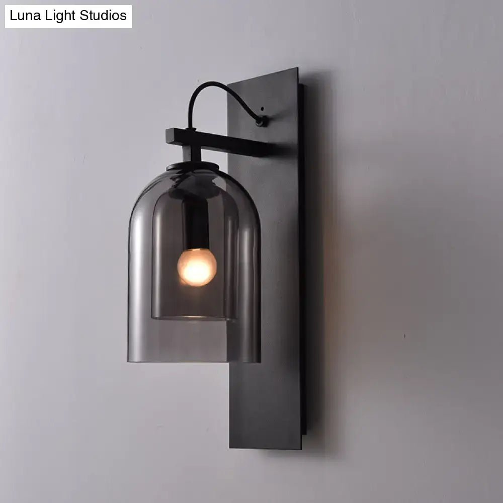 Mid-century black wall sconce with smoked dome glass shade living room