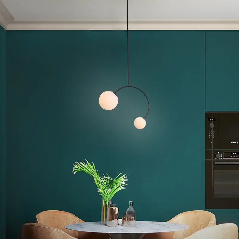 Minimalist black glass ball pendant lights – dining room curved arm