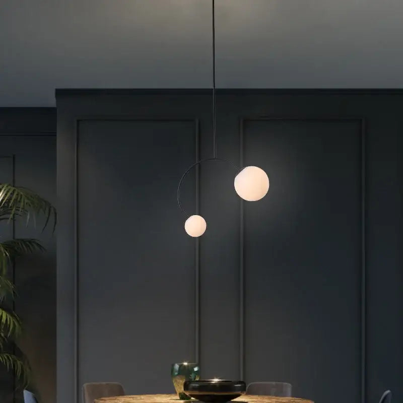 Minimalist black glass ball pendant lights – dining room curved arm