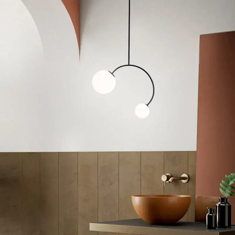 Minimalist black glass ball pendant lights – dining room curved arm