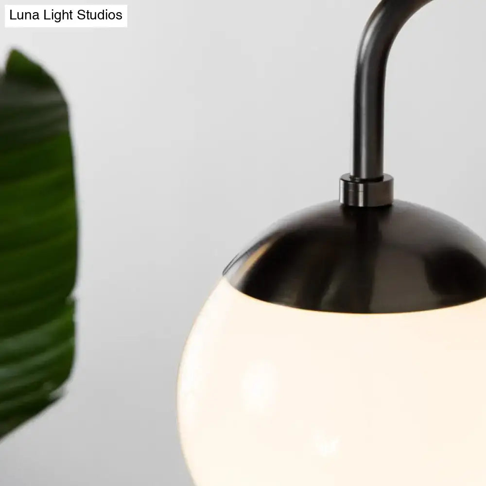 Minimalist black & gold wall light with milky glass ball for bedroom