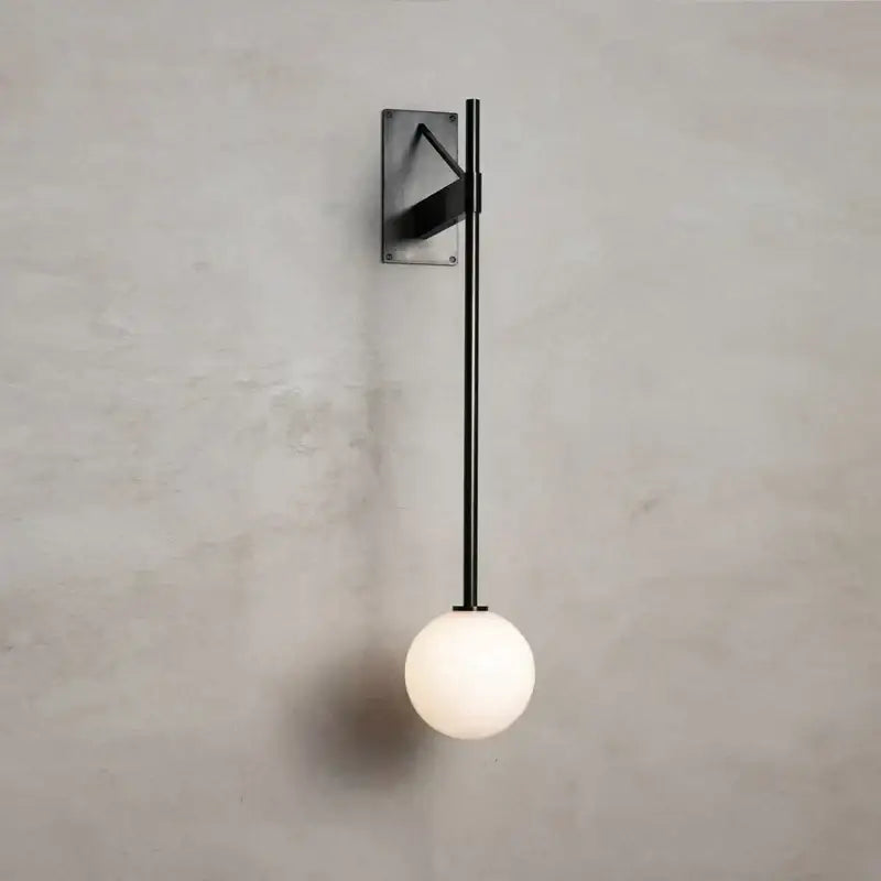 Minimalist geometric iron wall lamp with glass globe for bedroom