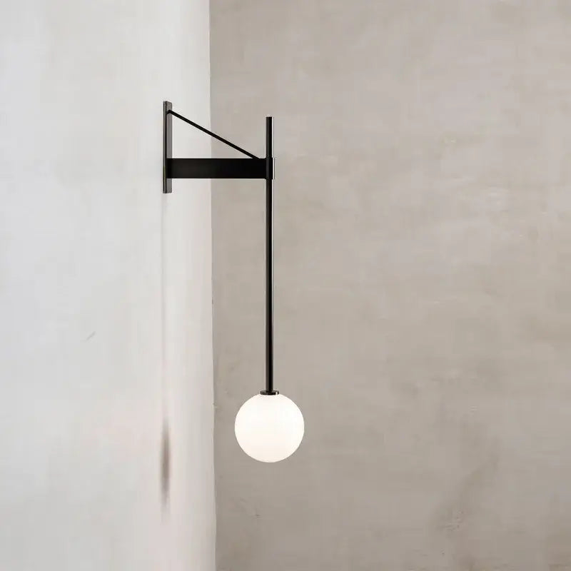 Minimalist geometric iron wall lamp with glass globe for bedroom