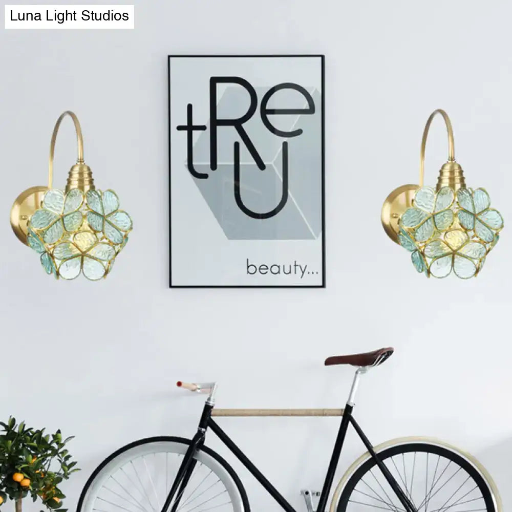 Minimalist gold floral wall sconce with glass shade for living room