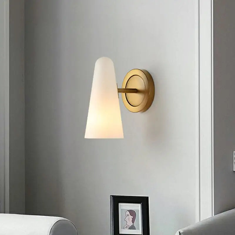 Minimalist gold wall sconce light with frosted glass shade living room