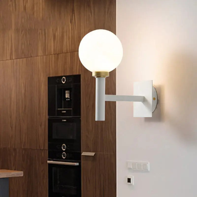 Minimalist white and brass wall lamp with opal glass shade bedroom