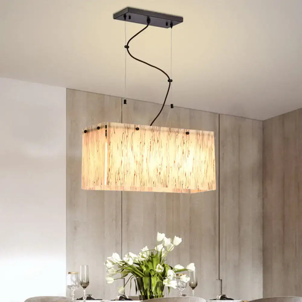 Modern black dining room pendant light with amber glass shade