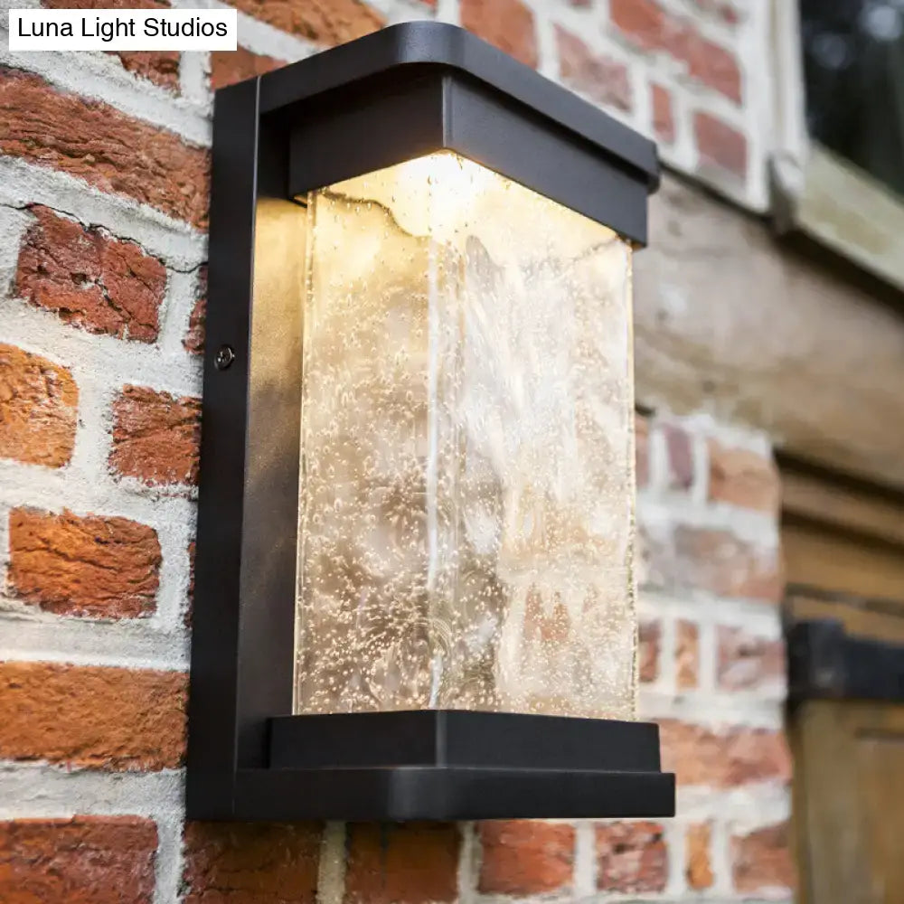 Modern black led outdoor wall sconce with rippled glass cylinder