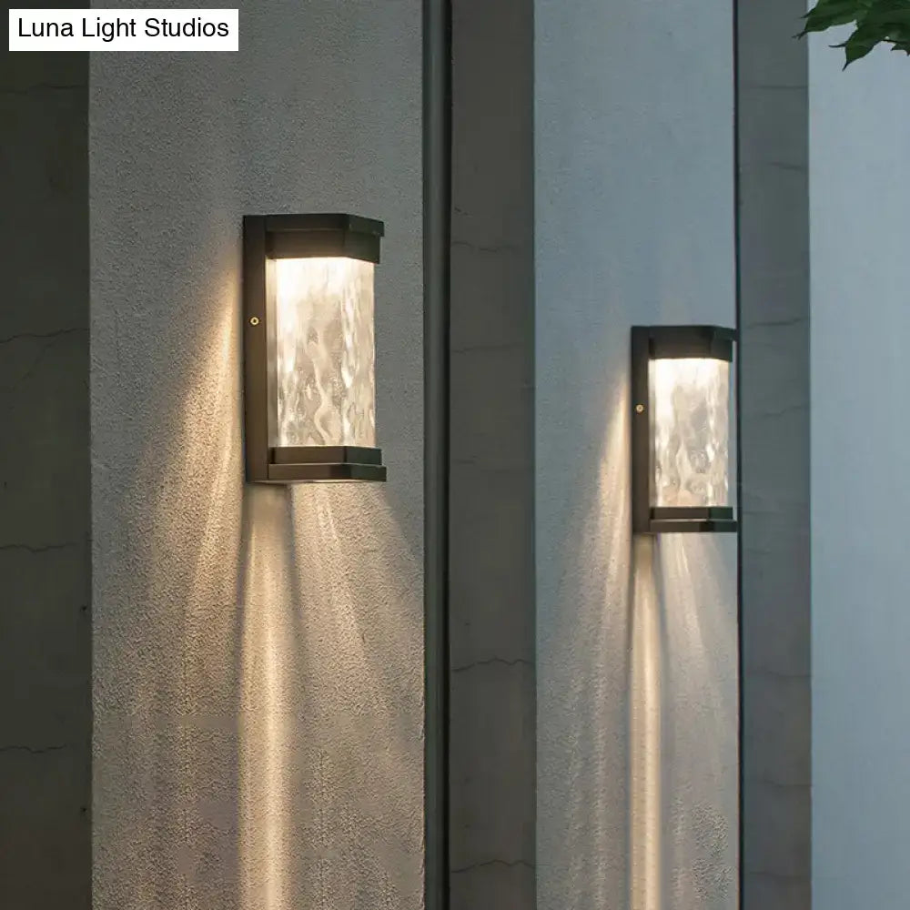 Modern black led outdoor wall sconce with rippled glass cylinder