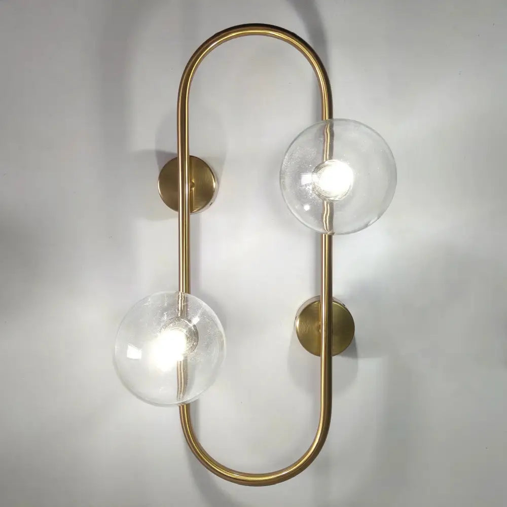 Modern black wall sconce with frosted glass globes – bedroom light