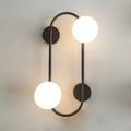 Modern black wall sconce with frosted glass globes – bedroom light
