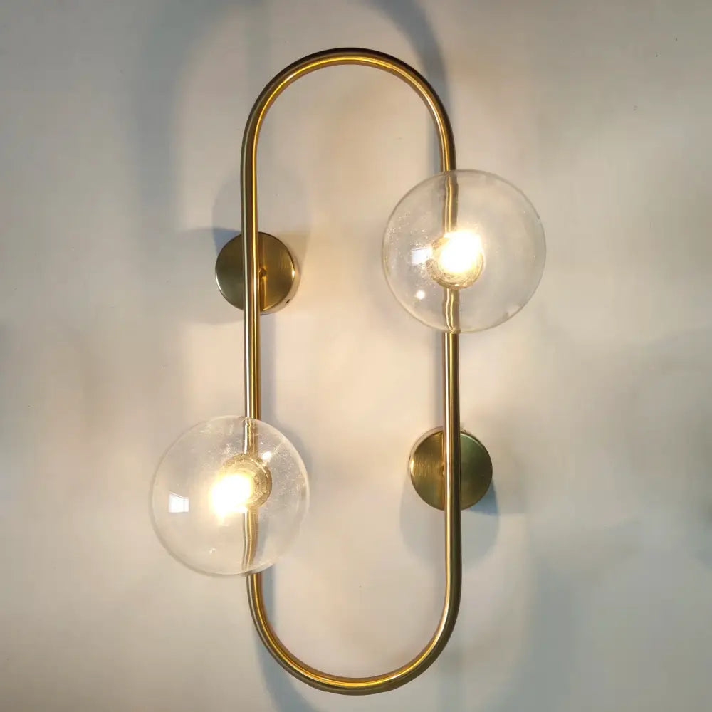 Modern black wall sconce with frosted glass globes – bedroom light