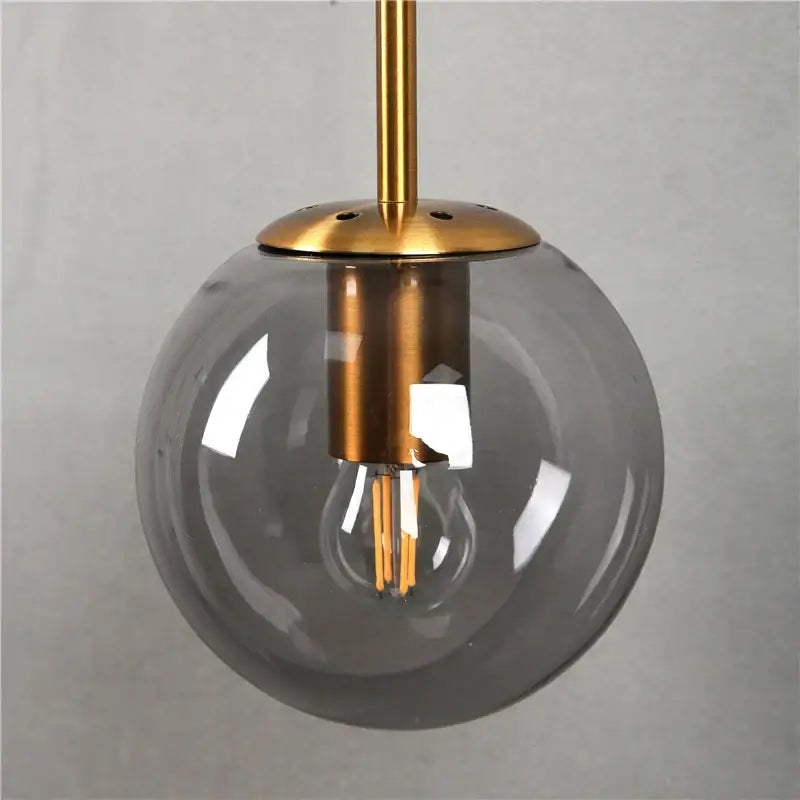 Modern brass and glass ball wall lamp for bedroom decor