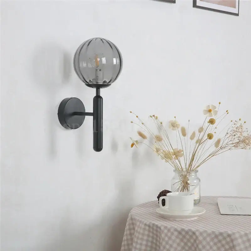 Modern brass and pink glass wall sconce for bedroom