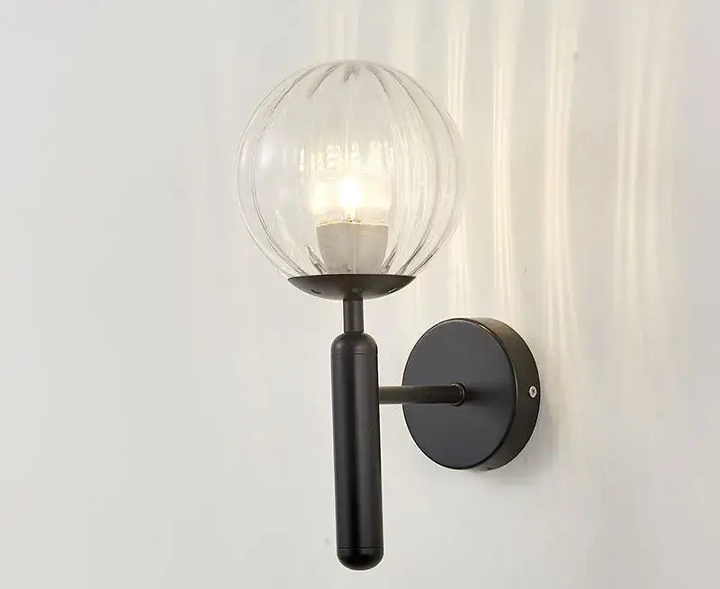 Modern brass and pink glass wall sconce for bedroom