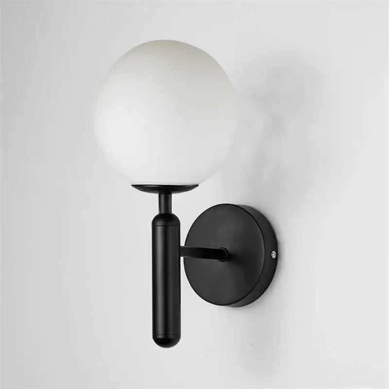 Modern brass and pink glass wall sconce for bedroom