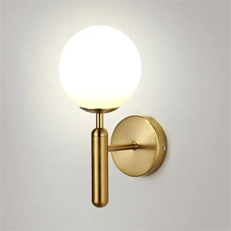 Modern brass and pink glass wall sconce for bedroom