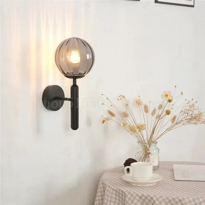 Modern brass and pink glass wall sconce for bedroom