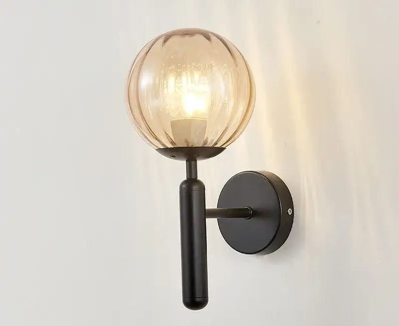 Modern brass and pink glass wall sconce for bedroom
