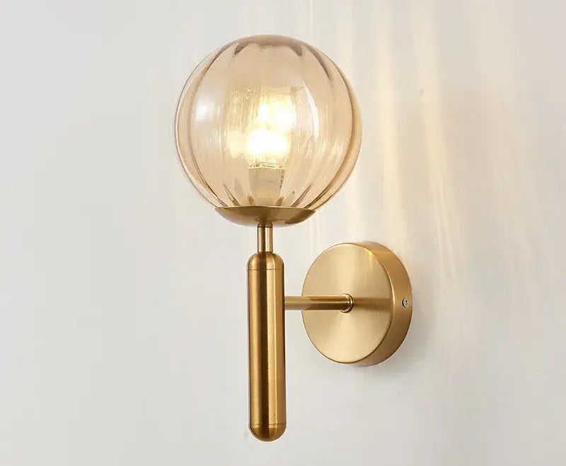 Modern brass and pink glass wall sconce for bedroom