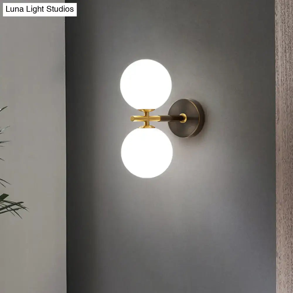 Modern brass and white glass wall sconce – bedroom globe light