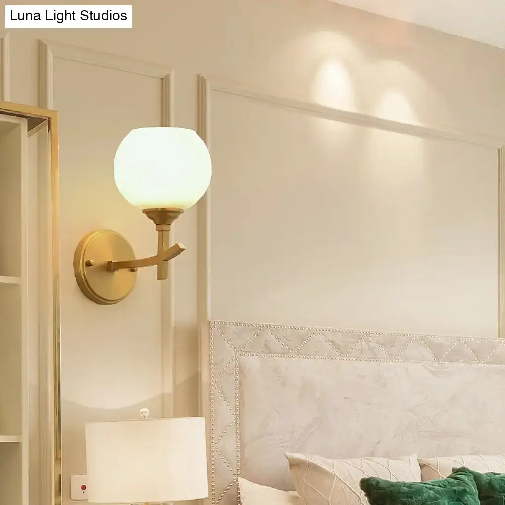 Modern brass armed sconce with opal glass shade bedroom wall lamp