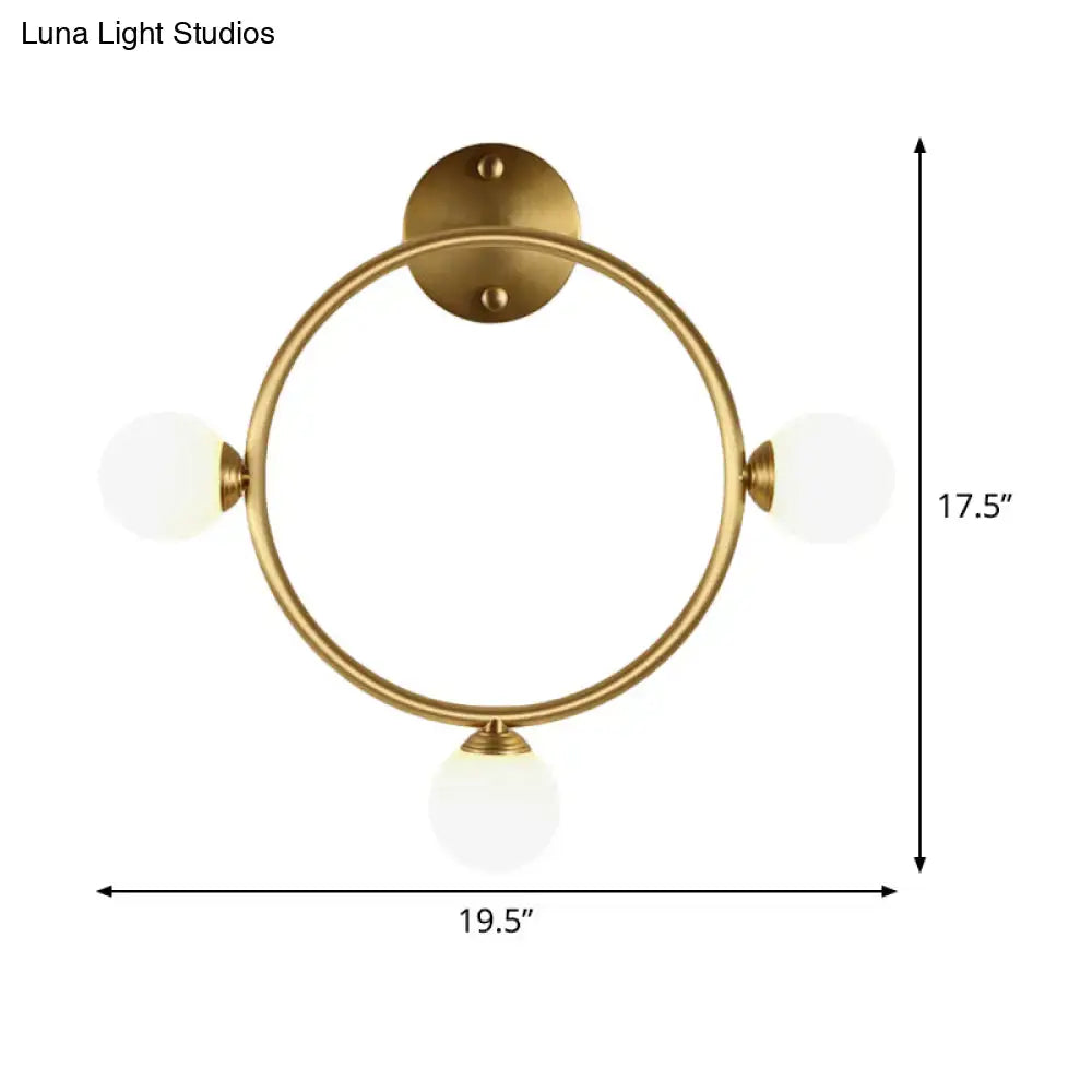 Modern brass circular wall light fixture with glass shades bedroom