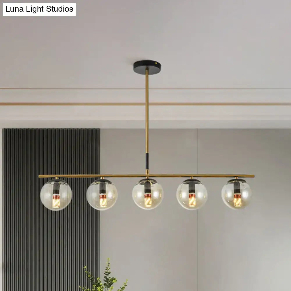 Modern brass dining room pendant light with cognac glass shades