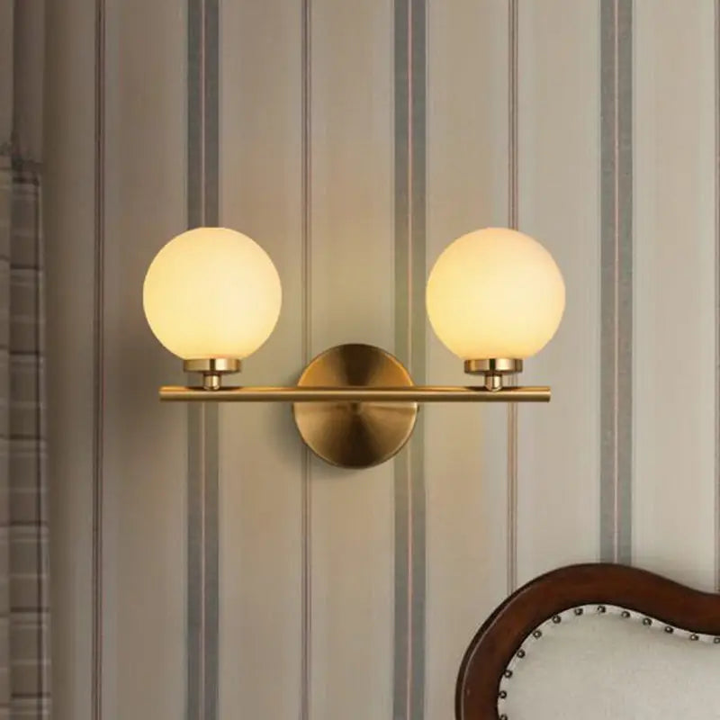 Modern brass light fixture with glass product shade – bedroom sconce