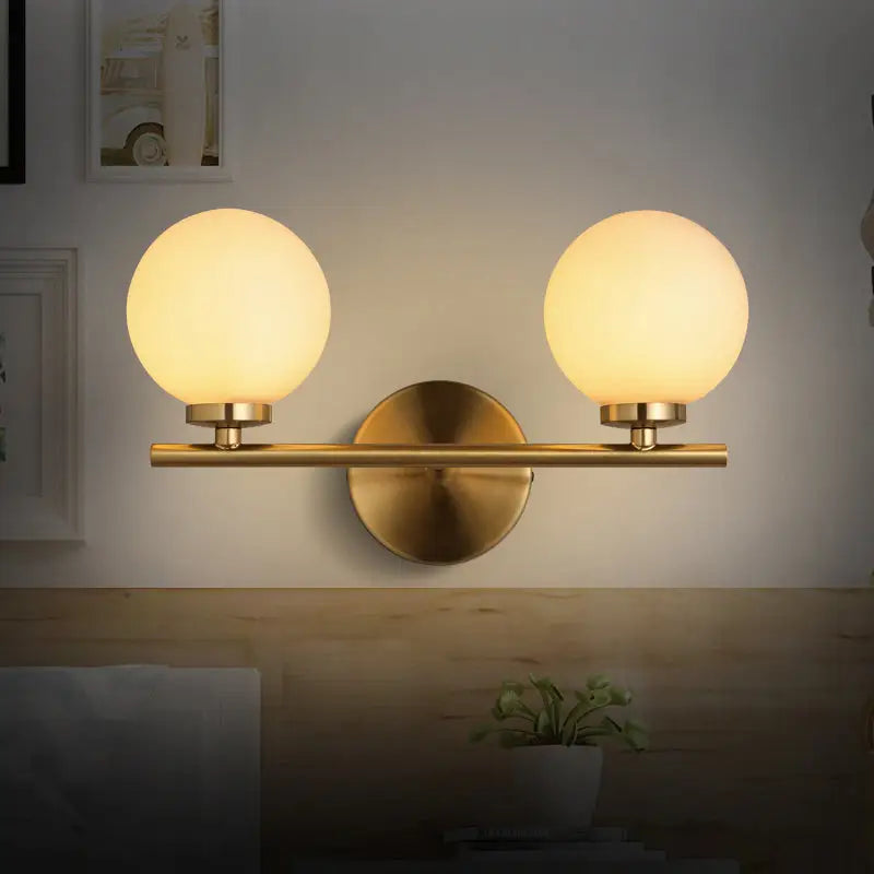 Modern brass light fixture with glass product shade – bedroom sconce