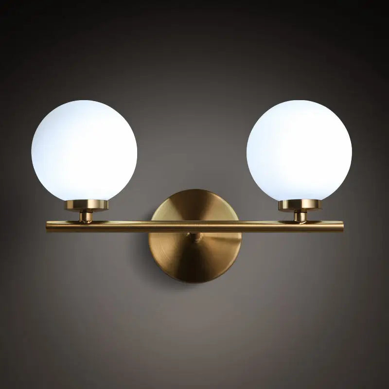 Modern brass light fixture with glass product shade – bedroom sconce