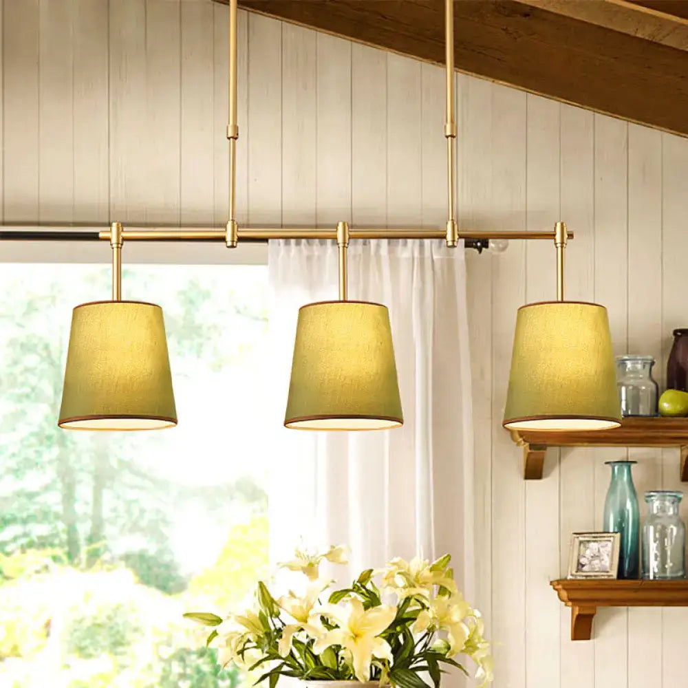 Modern brass pendant light with white green flaxen shades dining room