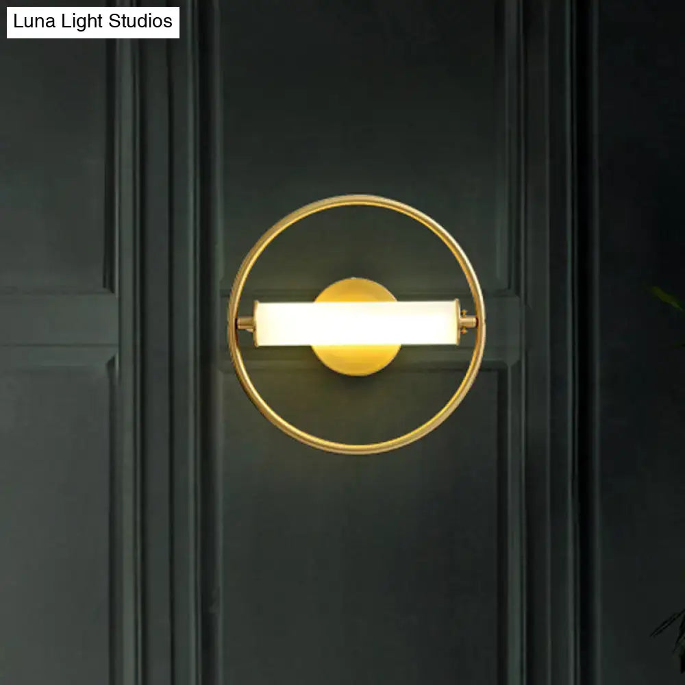 Modern brass ring wall sconce with opal glass shade bedroom light