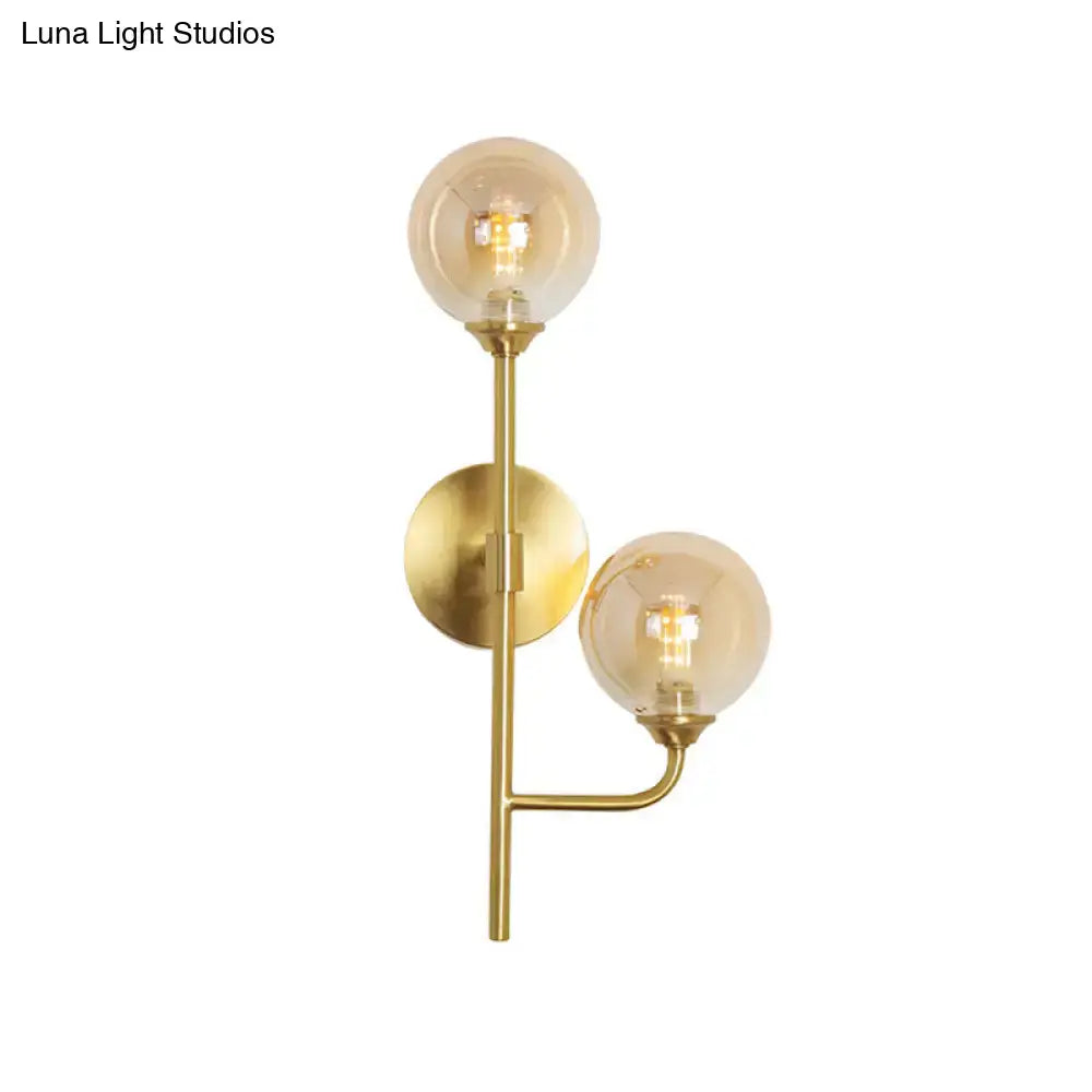 Modern brass sphere wall sconce amber & smoke gray bathroom light