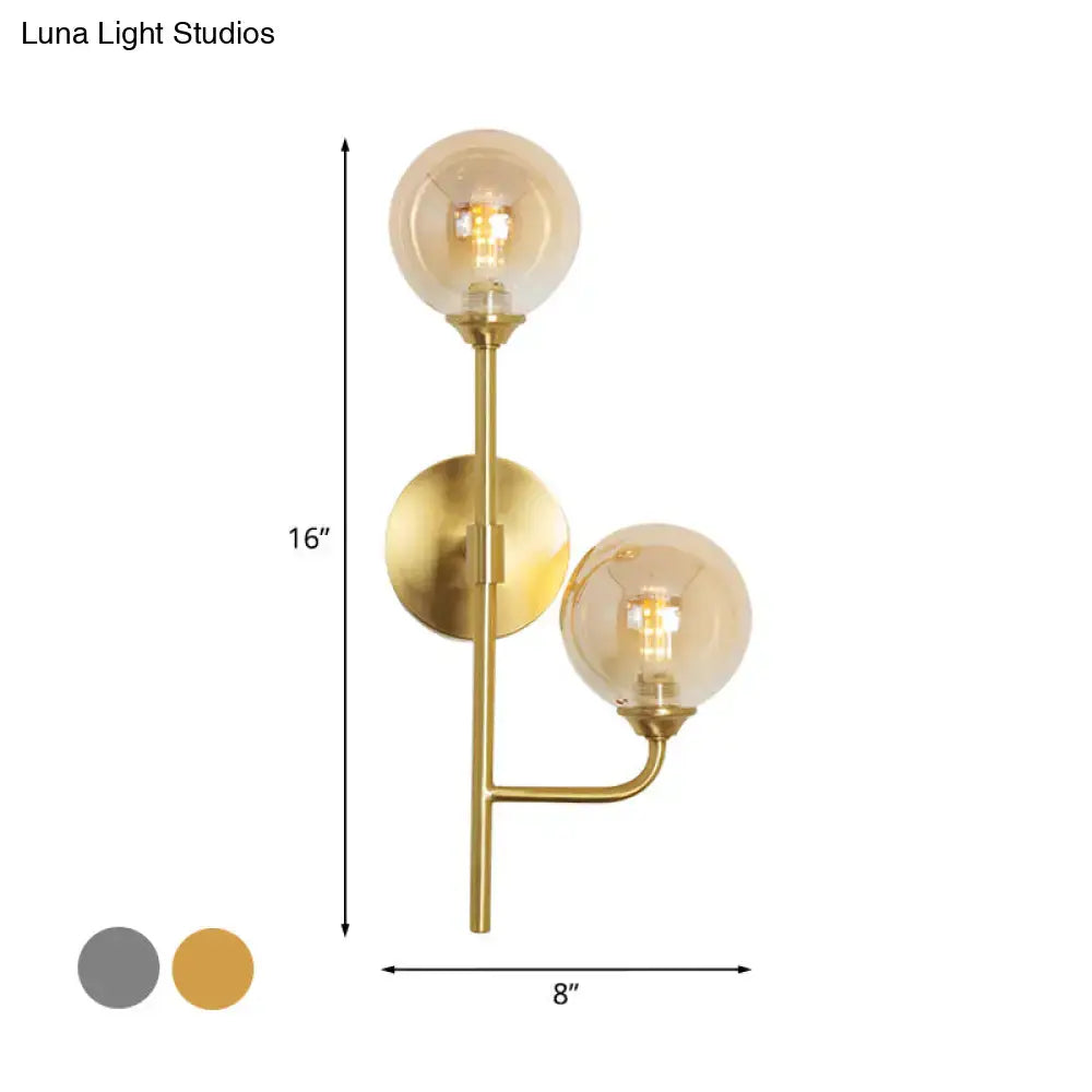 Modern brass sphere wall sconce amber & smoke gray bathroom light