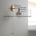 Modern brass wall lamp with clear glass shade bedroom reading light