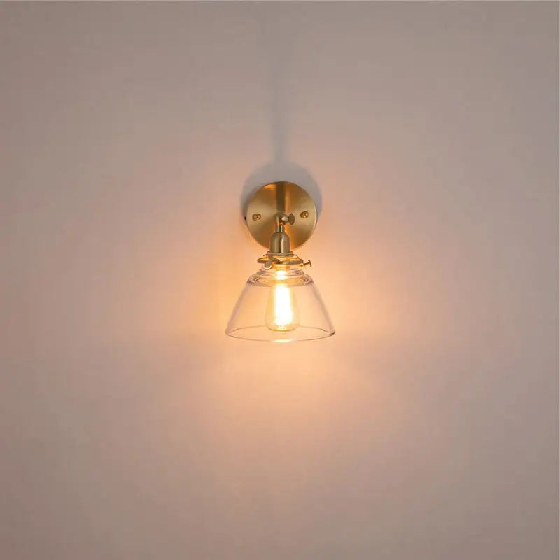 Modern brass wall lamp with clear glass shade bedroom reading light
