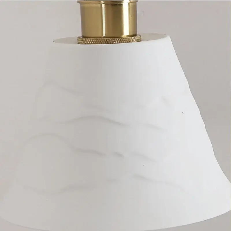 Modern brass wall lamp with frosted glass shade for bedroom reading