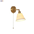 Modern brass wall lamp with frosted glass shade for bedroom reading