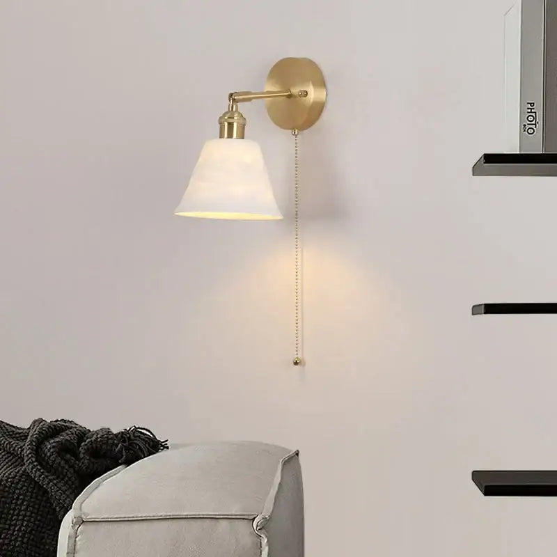 Modern brass wall lamp with frosted glass shade for bedroom reading