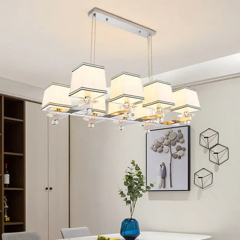 Modern chrome island pendant light with cream shades for dining rooms