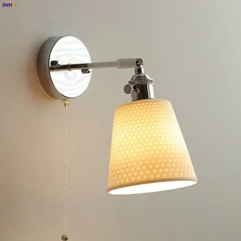 Modern chrome wall light with perforated fabric shade for bedroom