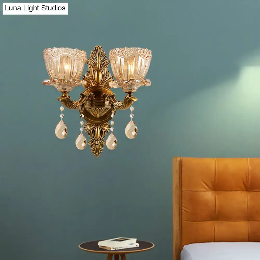 Modern floral brass wall sconce with teardrop crystal drop living room