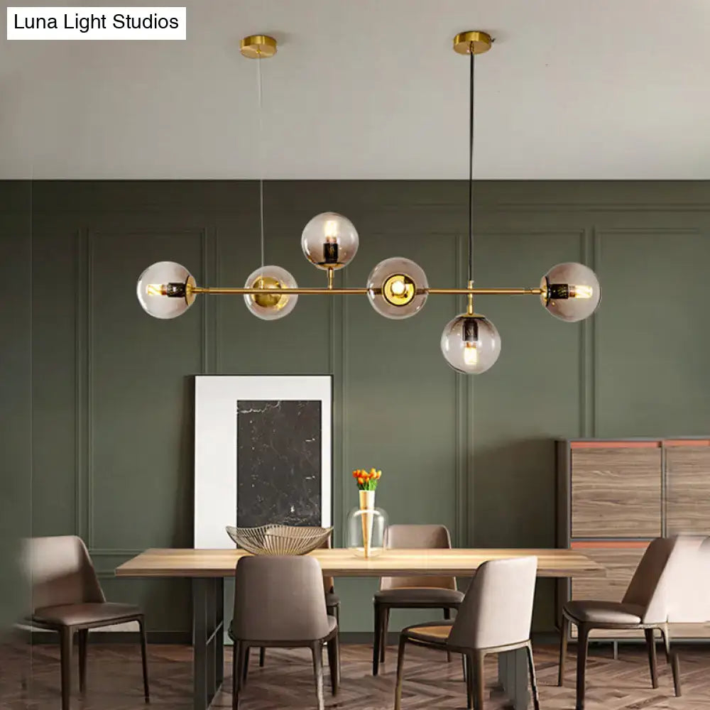 Modern gold island pendant light with glass globes for dining room
