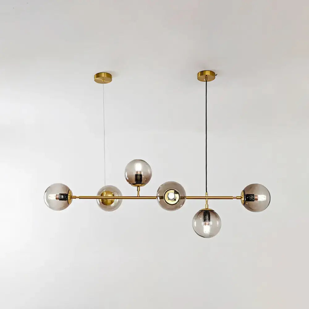 Modern gold island pendant light with glass globes for dining room