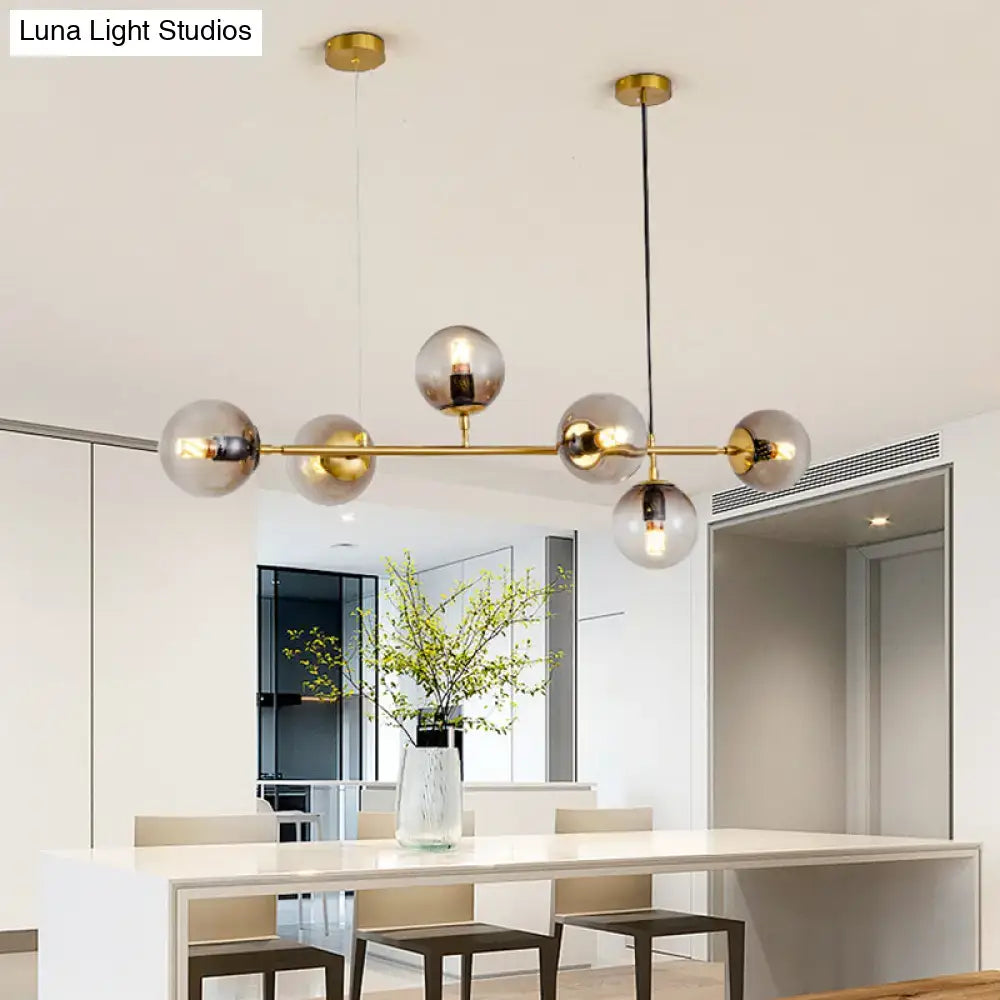 Modern gold island pendant light with glass globes for dining room
