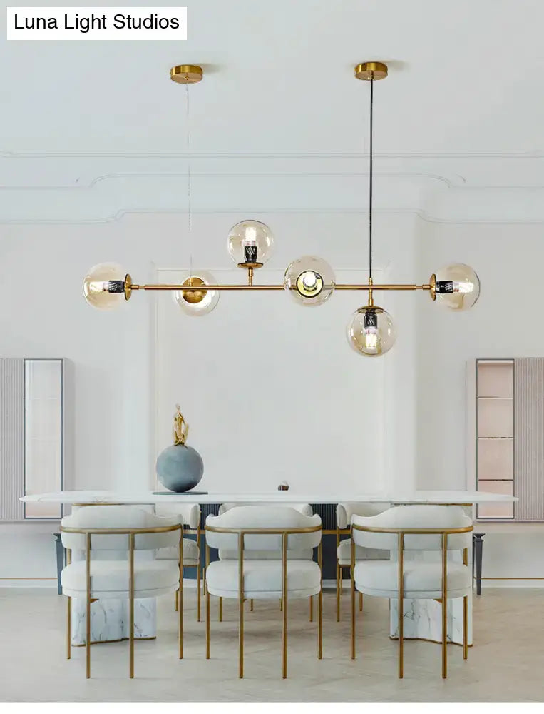 Modern gold island pendant light with glass globes for dining room